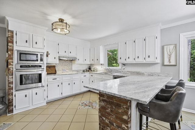 111 Rusty Barn Rd, Columbia, SC 29212 - kitchen with stainless steel appliances, a peninsula, a sink, white cabinets, and crown molding