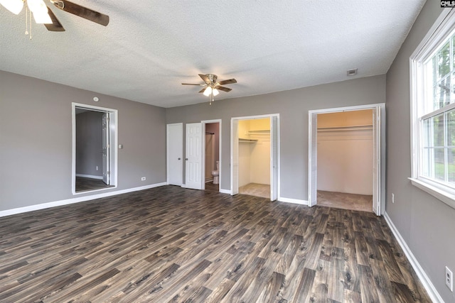 137 Wingate St, Darlington, SC 29532 - unfurnished bedroom featuring dark wood-style floors, multiple windows, a textured ceiling, and baseboards