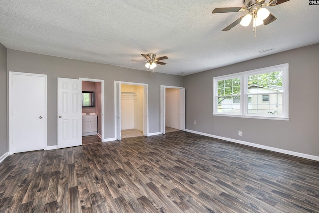 137 Wingate St, Darlington, SC 29532 - unfurnished bedroom with dark wood-style flooring, baseboards, a textured ceiling, and ensuite bathroom
