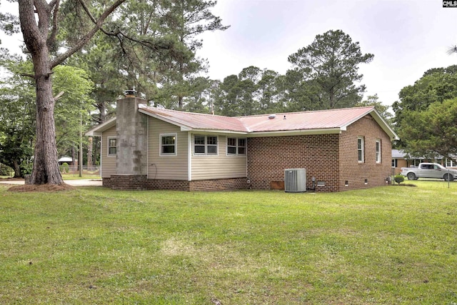 137 Wingate St, Darlington, SC 29532 - back of house featuring central AC unit, crawl space, a chimney, a yard, and metal roof