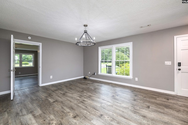137 Wingate St, Darlington, SC 29532 - empty room with a chandelier, dark wood-type flooring, a textured ceiling, and baseboards