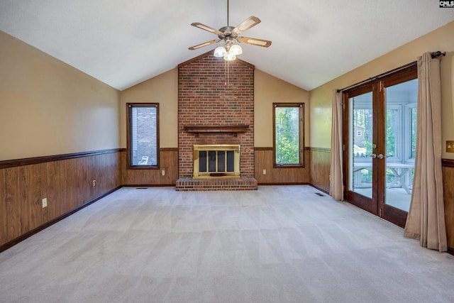 800 Wotan Rd, Columbia, SC 29229 - unfurnished living room with wainscoting, a ceiling fan, wood walls, vaulted ceiling, and carpet flooring
