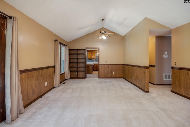 800 Wotan Rd, Columbia, SC 29229 - spare room featuring a wainscoted wall, a ceiling fan, wooden walls, vaulted ceiling, and light carpet