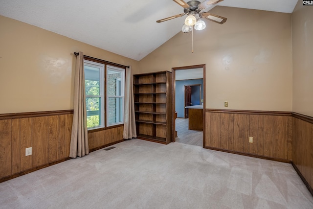 800 Wotan Rd, Columbia, SC 29229 - spare room with wainscoting, wooden walls, a ceiling fan, light carpet, and high vaulted ceiling