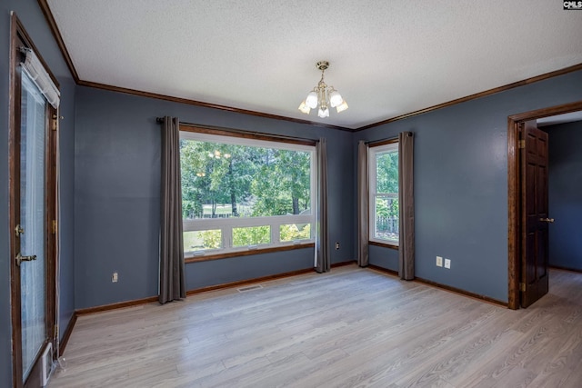 800 Wotan Rd, Columbia, SC 29229 - empty room with a chandelier, crown molding, light wood finished floors, a textured ceiling, and healthy amount of natural light