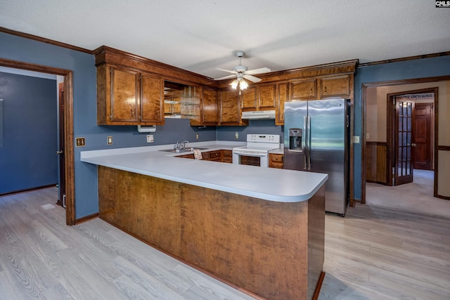 800 Wotan Rd, Columbia, SC 29229 - kitchen with electric range, stainless steel fridge, under cabinet range hood, a sink, and brown cabinets