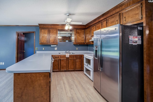 800 Wotan Rd, Columbia, SC 29229 - kitchen featuring stainless steel fridge, a sink, double oven range, light wood-type flooring, and a peninsula
