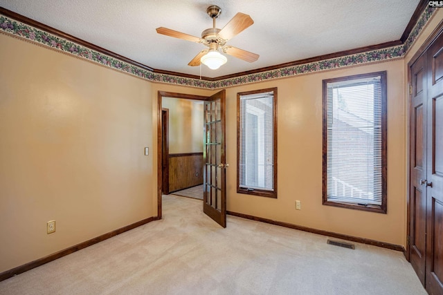 800 Wotan Rd, Columbia, SC 29229 - spare room with light carpet, a textured ceiling, baseboards, ornamental molding, and a ceiling fan