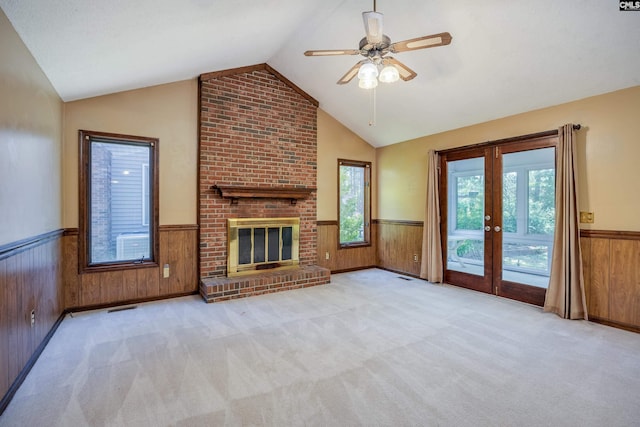 800 Wotan Rd, Columbia, SC 29229 - unfurnished living room featuring a wainscoted wall, wood walls, vaulted ceiling, healthy amount of natural light, and french doors