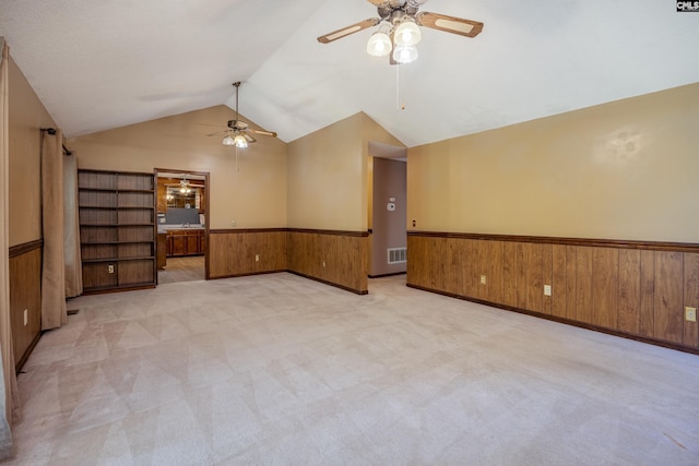 800 Wotan Rd, Columbia, SC 29229 - empty room with ceiling fan, a wainscoted wall, lofted ceiling, wooden walls, and light carpet