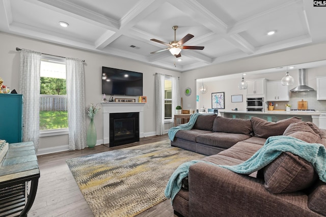 309 Springbrook Way, Chapin, SC 29036 - living area with coffered ceiling, a ceiling fan, light wood-type flooring, a fireplace with flush hearth, and beam ceiling
