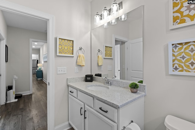 309 Springbrook Way, Chapin, SC 29036 - half bathroom featuring vanity, wood finished floors, toilet, and baseboards