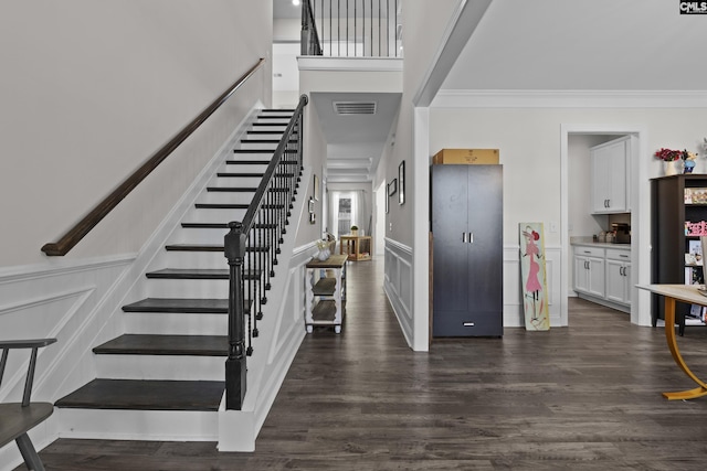309 Springbrook Way, Chapin, SC 29036 - foyer featuring stairs, a decorative wall, dark wood-style floors, crown molding, and a wainscoted wall