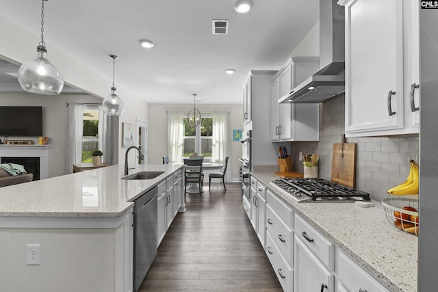 309 Springbrook Way, Chapin, SC 29036 - kitchen with wall chimney exhaust hood, a sink, appliances with stainless steel finishes, a kitchen island with sink, and dark wood-style floors