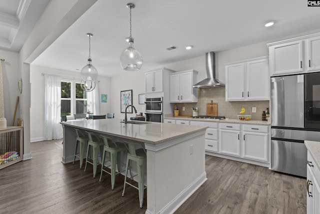 309 Springbrook Way, Chapin, SC 29036 - kitchen with appliances with stainless steel finishes, wall chimney exhaust hood, dark wood-style floors, a sink, and an island with sink
