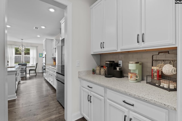 309 Springbrook Way, Chapin, SC 29036 - kitchen featuring white cabinetry, tasteful backsplash, dark wood-style floors, recessed lighting, and light stone countertops