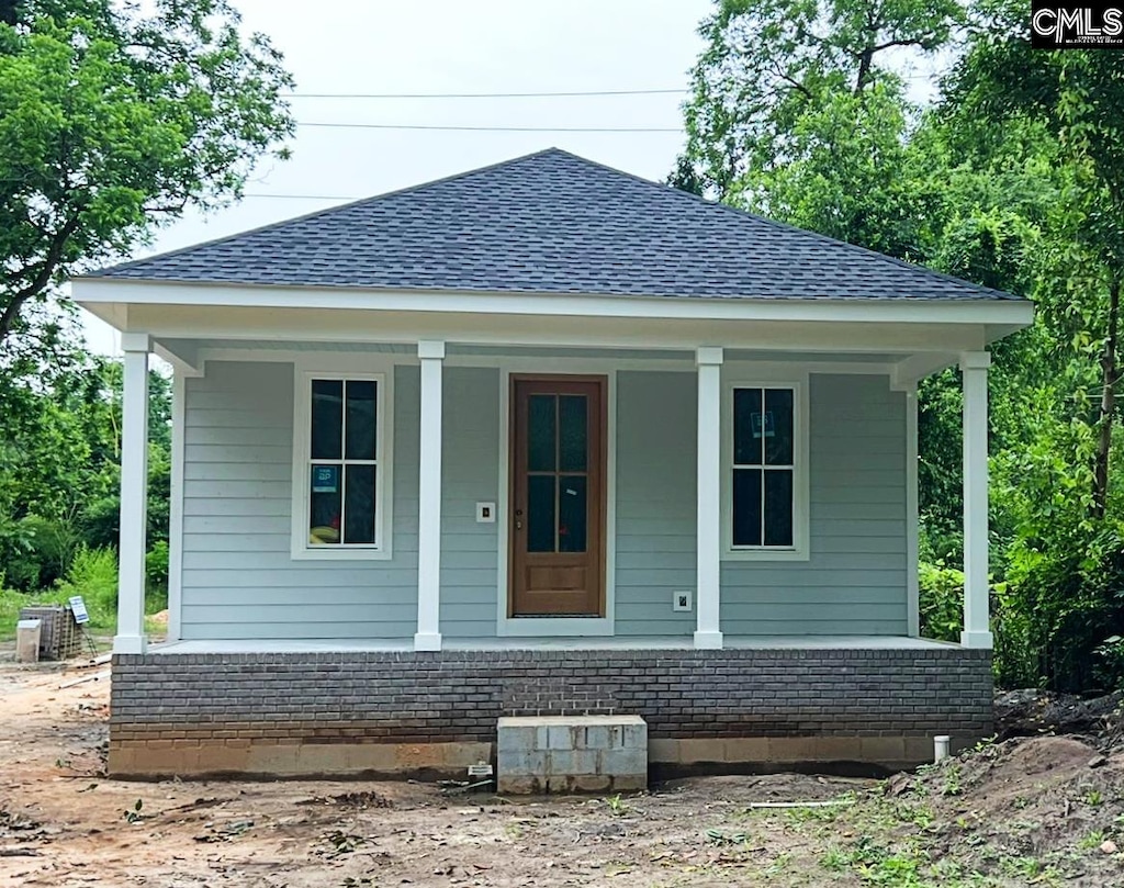 2408 Greene St, Columbia, SC 29205 - view of front facade featuring covered porch, roof with shingles, and central AC