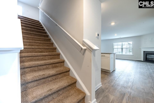 158 Dunham Rd, Columbia, SC 29209 - stairs featuring wood finished floors, baseboards, a glass covered fireplace, and recessed lighting