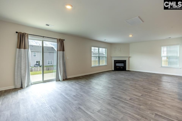158 Dunham Rd, Columbia, SC 29209 - unfurnished living room with healthy amount of natural light, wood finished floors, baseboards, and recessed lighting