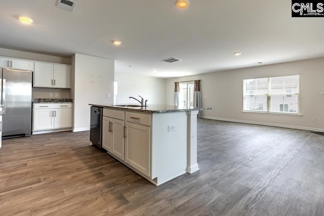 158 Dunham Rd, Columbia, SC 29209 - kitchen featuring stainless steel fridge, a sink, dishwashing machine, dark stone countertops, and dark wood finished floors