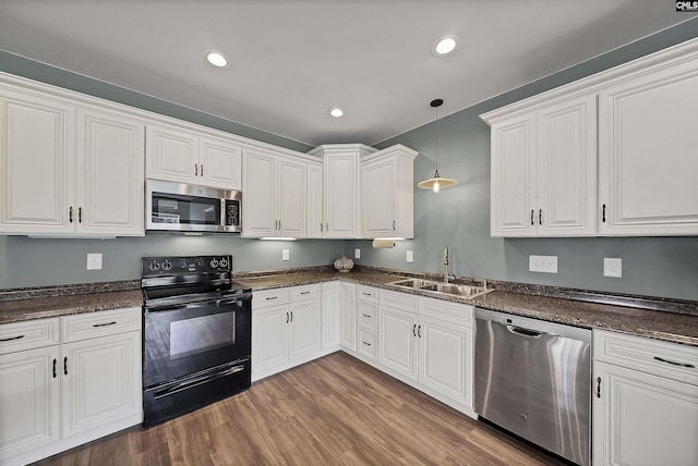 1122 Rawl Rd, Lexington, SC 29072 - kitchen featuring appliances with stainless steel finishes, a sink, wood finished floors, white cabinets, and decorative light fixtures