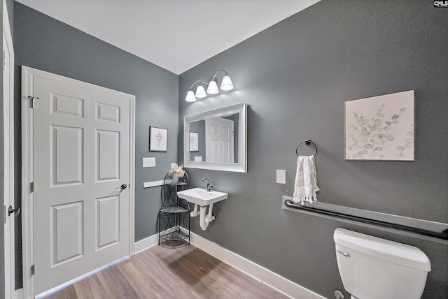 1122 Rawl Rd, Lexington, SC 29072 - half bathroom featuring toilet, wood finished floors, baseboards, and a sink