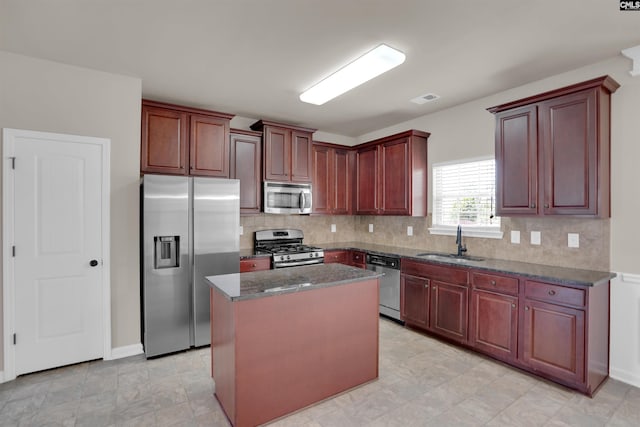 506 Moulton Way W, Columbia, SC 29170 - kitchen featuring stainless steel appliances, a sink, backsplash, a kitchen island, and dark stone counters