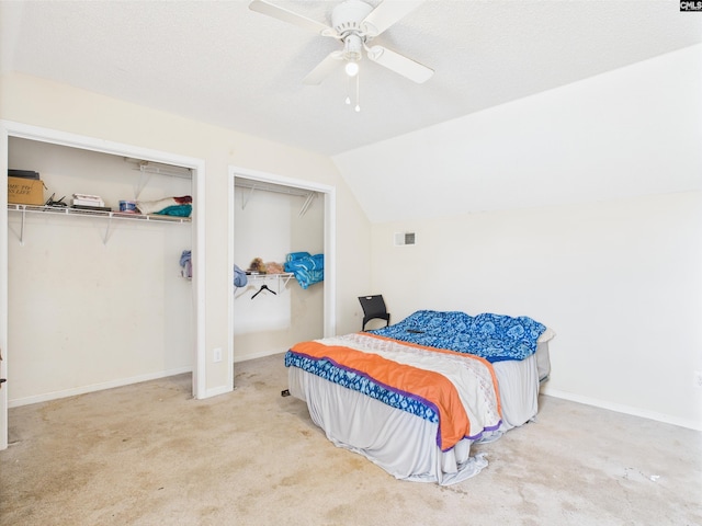 40 Driftwood Ave, Elgin, SC 29045 - bedroom with vaulted ceiling, two closets, carpet flooring, a ceiling fan, and baseboards