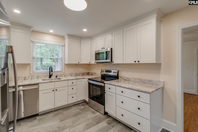 6319 Briarwood Rd, Columbia, SC 29206 - kitchen with stainless steel appliances, a sink, white cabinetry, light stone countertops, and recessed lighting