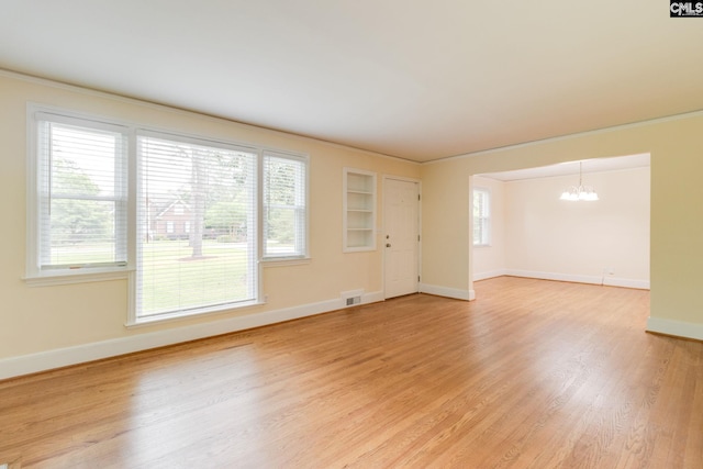 6319 Briarwood Rd, Columbia, SC 29206 - empty room with a chandelier, baseboards, light wood-type flooring, and crown molding