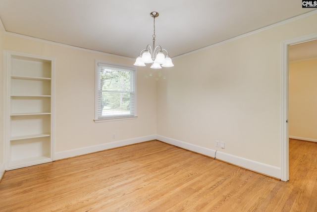 6319 Briarwood Rd, Columbia, SC 29206 - spare room with a chandelier, crown molding, light wood-type flooring, baseboards, and built in features