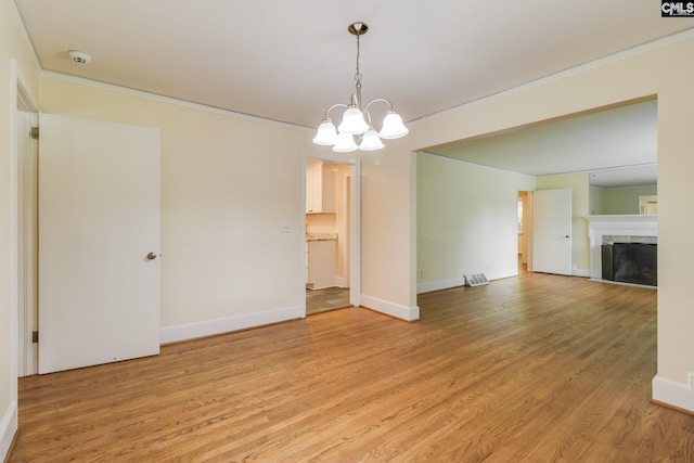6319 Briarwood Rd, Columbia, SC 29206 - spare room featuring ornamental molding, light wood finished floors, a chandelier, a smoke detector, and baseboards