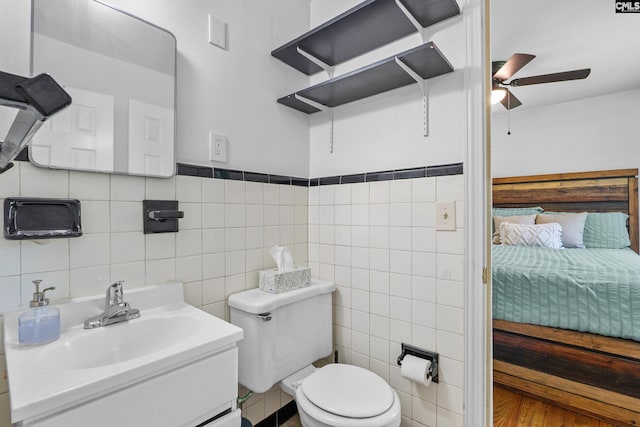 564 Rainbow Cir, West Columbia, SC 29170 - ensuite bathroom with ceiling fan, tile walls, toilet, and vanity