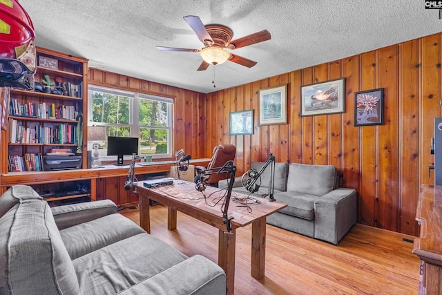 564 Rainbow Cir, West Columbia, SC 29170 - home office with ceiling fan, wooden walls, light wood finished floors, and a textured ceiling