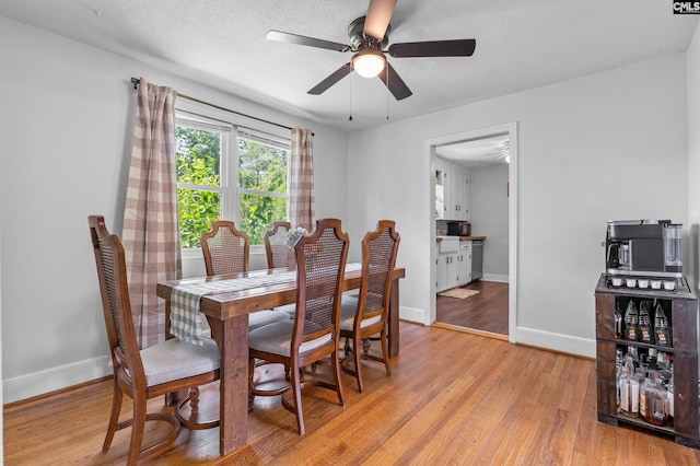 564 Rainbow Cir, West Columbia, SC 29170 - dining room with baseboards, light wood-style floors, and ceiling fan