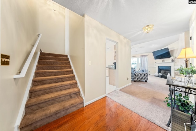 5 Indigo Lake Ct, Columbia, SC 29229 - staircase featuring wood finished floors, a fireplace, and baseboards