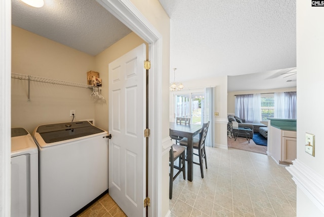 5 Indigo Lake Ct, Columbia, SC 29229 - laundry area featuring washer and dryer, a textured ceiling, baseboards, and a chandelier