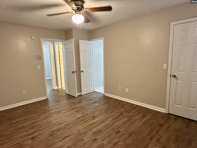26 Someton Ct, Irmo, SC 29063 - unfurnished bedroom with dark wood-type flooring, baseboards, a textured ceiling, and a ceiling fan