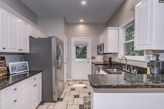 615 Laurel Hill Ln, Columbia, SC 29201 - kitchen featuring appliances with stainless steel finishes, a sink, white cabinets, dark stone countertops, and recessed lighting