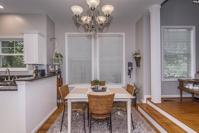 615 Laurel Hill Ln, Columbia, SC 29201 - dining space featuring a chandelier, light wood-style floors, baseboards, and healthy amount of natural light