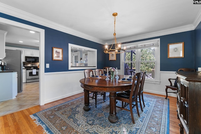 1130 Coatesdale Rd, Columbia, SC 29209 - dining space featuring a chandelier, crown molding, wainscoting, and light wood finished floors