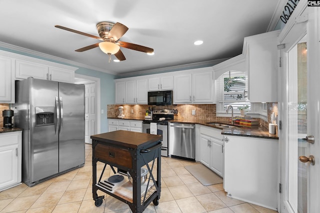 1130 Coatesdale Rd, Columbia, SC 29209 - kitchen with appliances with stainless steel finishes, a sink, a ceiling fan, tasteful backsplash, and ornamental molding
