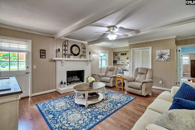 225 King Charles Rd, Columbia, SC 29209 - living room featuring ornamental molding, plenty of natural light, beamed ceiling, a brick fireplace, and wood finished floors