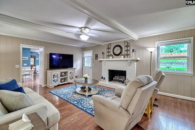 225 King Charles Rd, Columbia, SC 29209 - living room featuring hardwood / wood-style floors, a brick fireplace, beam ceiling, crown molding, and a ceiling fan