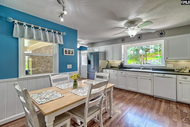 225 King Charles Rd, Columbia, SC 29209 - dining area with a ceiling fan, wood finished floors, a textured ceiling, plenty of natural light, and wainscoting