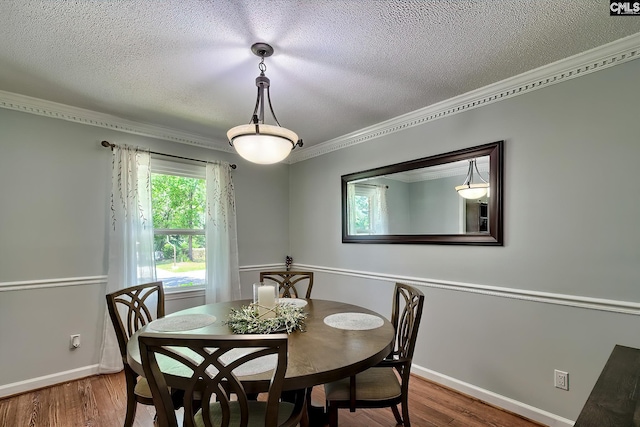 225 King Charles Rd, Columbia, SC 29209 - dining space with ornamental molding, wood finished floors, a textured ceiling, and baseboards