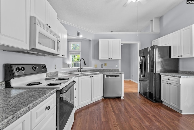 140 Whispering Glen Cir, West Columbia, SC 29170 - kitchen with white microwave, stainless steel dishwasher, range with electric stovetop, a sink, and freestanding refrigerator