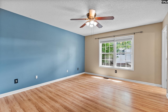 140 Whispering Glen Cir, West Columbia, SC 29170 - empty room with a textured ceiling, a ceiling fan, wood finished floors, and baseboards