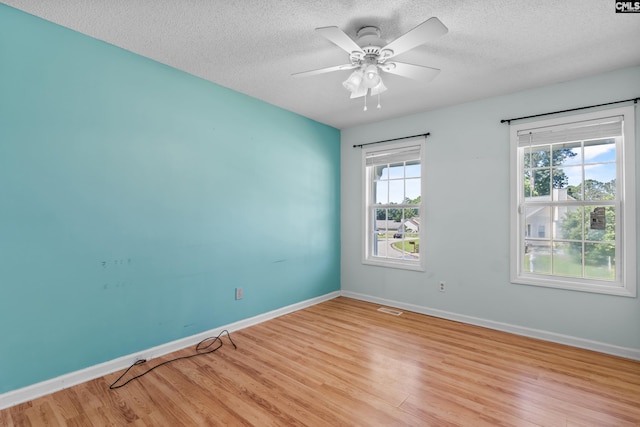 140 Whispering Glen Cir, West Columbia, SC 29170 - spare room featuring light wood-style floors, a textured ceiling, baseboards, and a ceiling fan