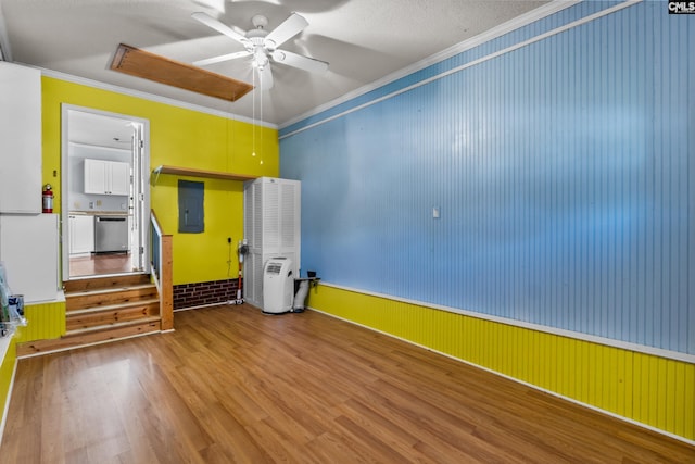 140 Whispering Glen Cir, West Columbia, SC 29170 - empty room featuring wood finished floors, ornamental molding, a ceiling fan, electric panel, and a wainscoted wall